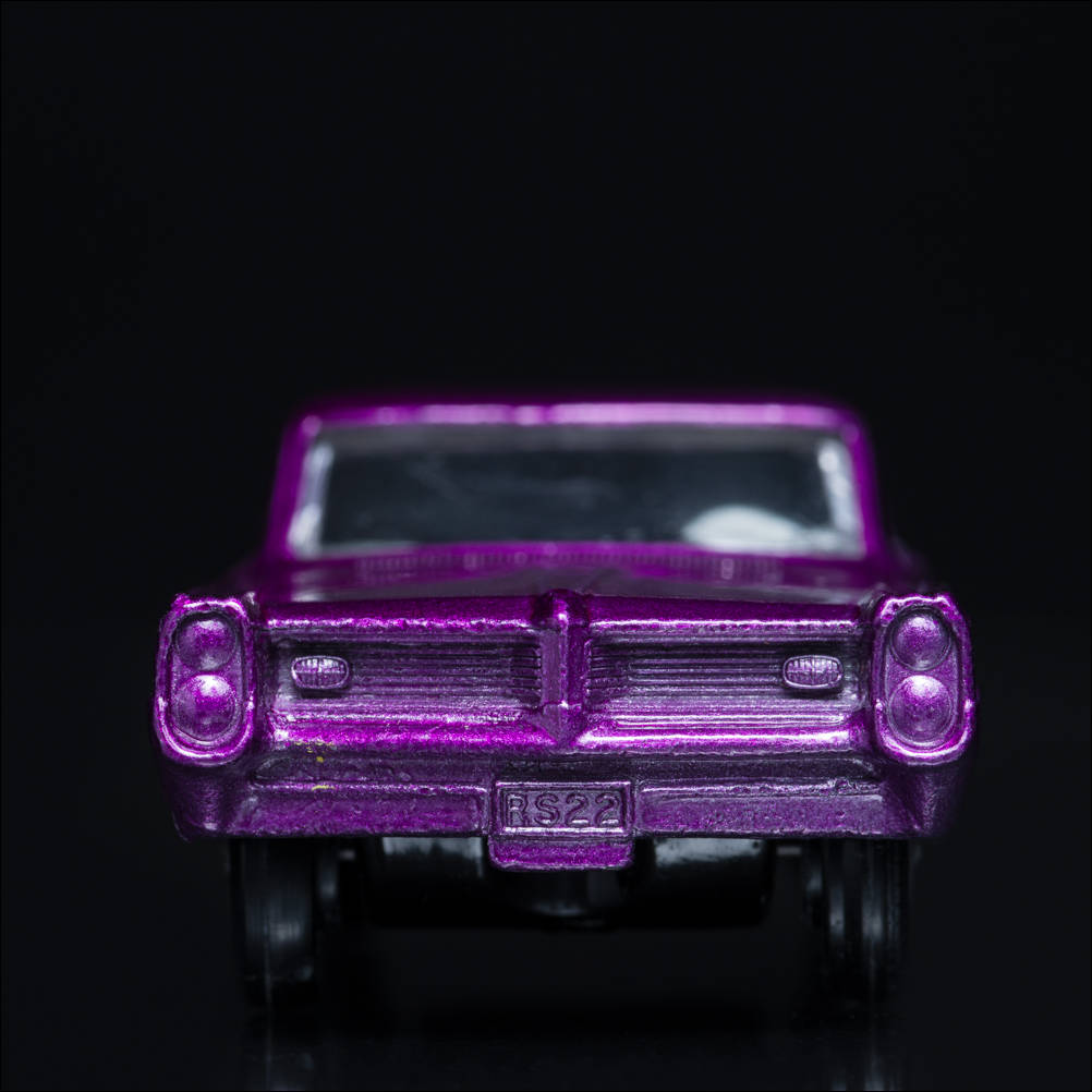 From the Carface collection. Pontiac GP Sport Coupe Purple, Matchbox Series No. 22. A color photograph by Jeff Kauffman of a vintage matchbox car. ©Jeff Kauffman