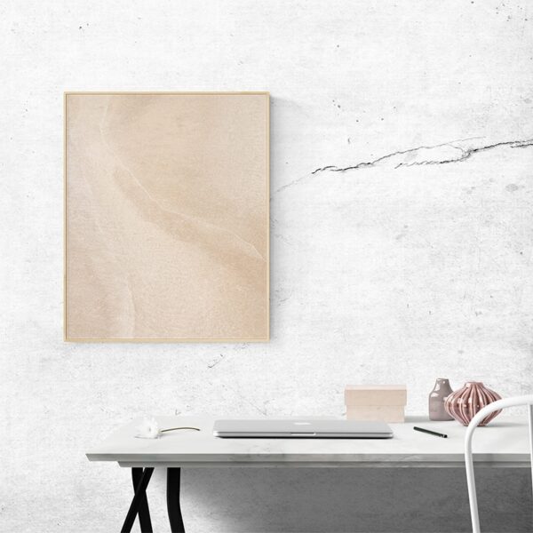 Fine-art print in minimalist workspace with marble wall and modern decor for creative office design.