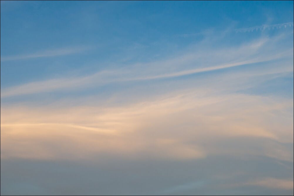 Expansive Sky #0116. Soft whispy clouds with an orange hue against a blue sky. Photograph by photographer Jeff Kauffman of Austin, Texas USA. ©Jeff Kauffman