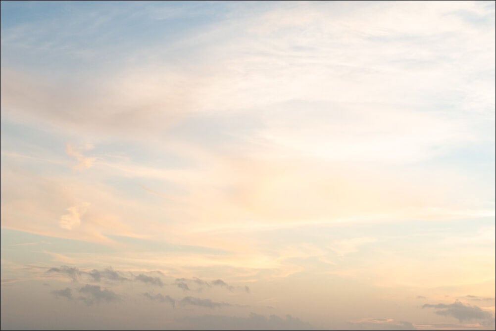 Expansive Sky #0123. Soft whispy clouds with an orange hue against a blue sky. Photograph by photographer Jeff Kauffman of Austin, Texas USA. ©Jeff Kauffman