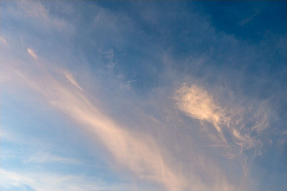 Expansive Sky #0133. Soft whispy clouds with an orange hue against a blue sky. Photograph by photographer Jeff Kauffman of Austin, Texas USA. ©Jeff Kauffman