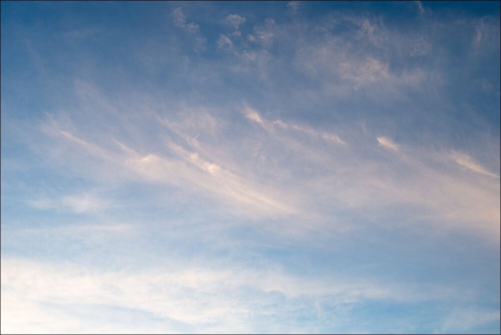 Expansive Sky #0134. Soft whispy clouds with an orange hue against a blue sky. Photograph by photographer Jeff Kauffman of Austin, Texas USA. ©Jeff Kauffman